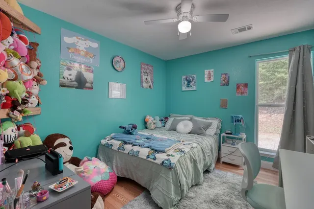 a bedroom with a bed and a tv