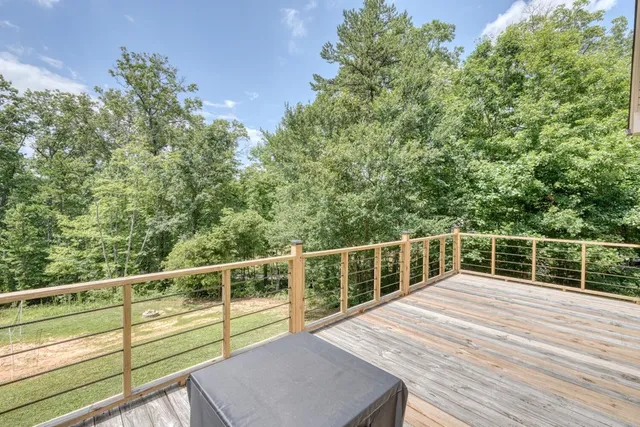 a view of a balcony with wooden floor and fence