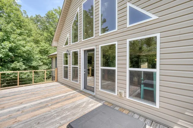 an aerial view of a house with a yard and lake view