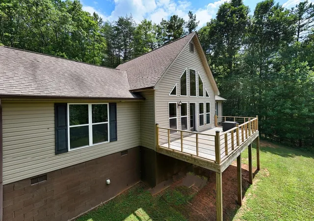 a view of house with yard and entertaining space