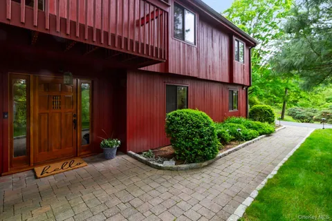 a view of a house with potted plants in front of door