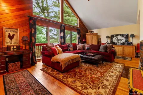 a dining room with furniture a rug and wooden floor