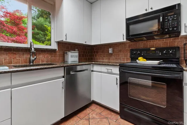 a view of a kitchen with a sink and a clock on the wall