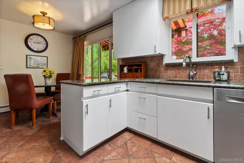 a kitchen with a table chairs and microwave
