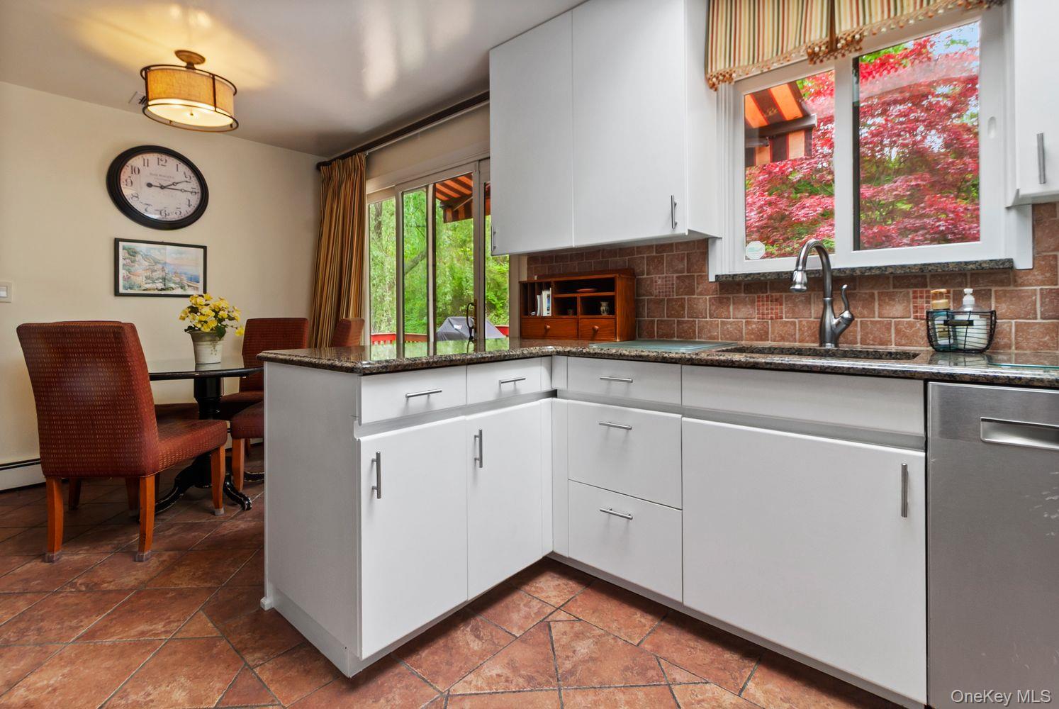 12 Ilana Court Armonk, NY 10504 - Photo 19 of 33 a view of a kitchen with a sink and a clock on the wall