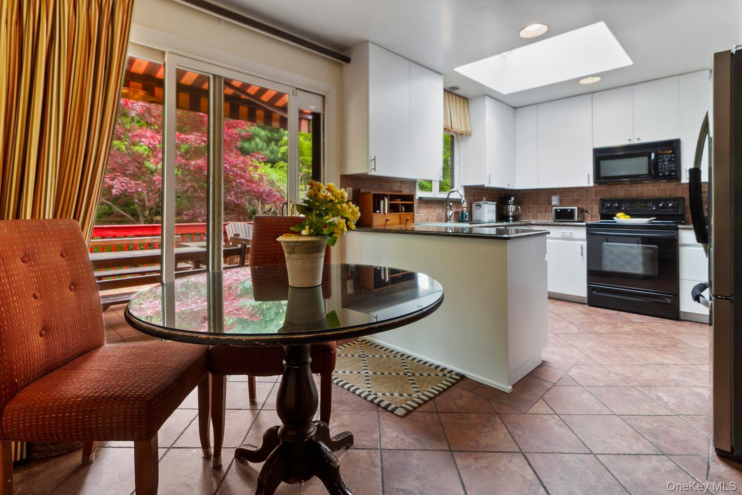 12 Ilana Court Armonk, NY 10504 - Photo 20 of 33 a kitchen with a table chairs and microwave