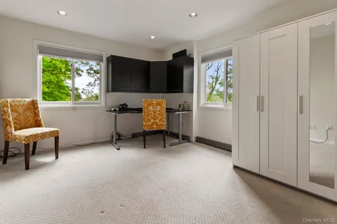 a bedroom with bed and a large window