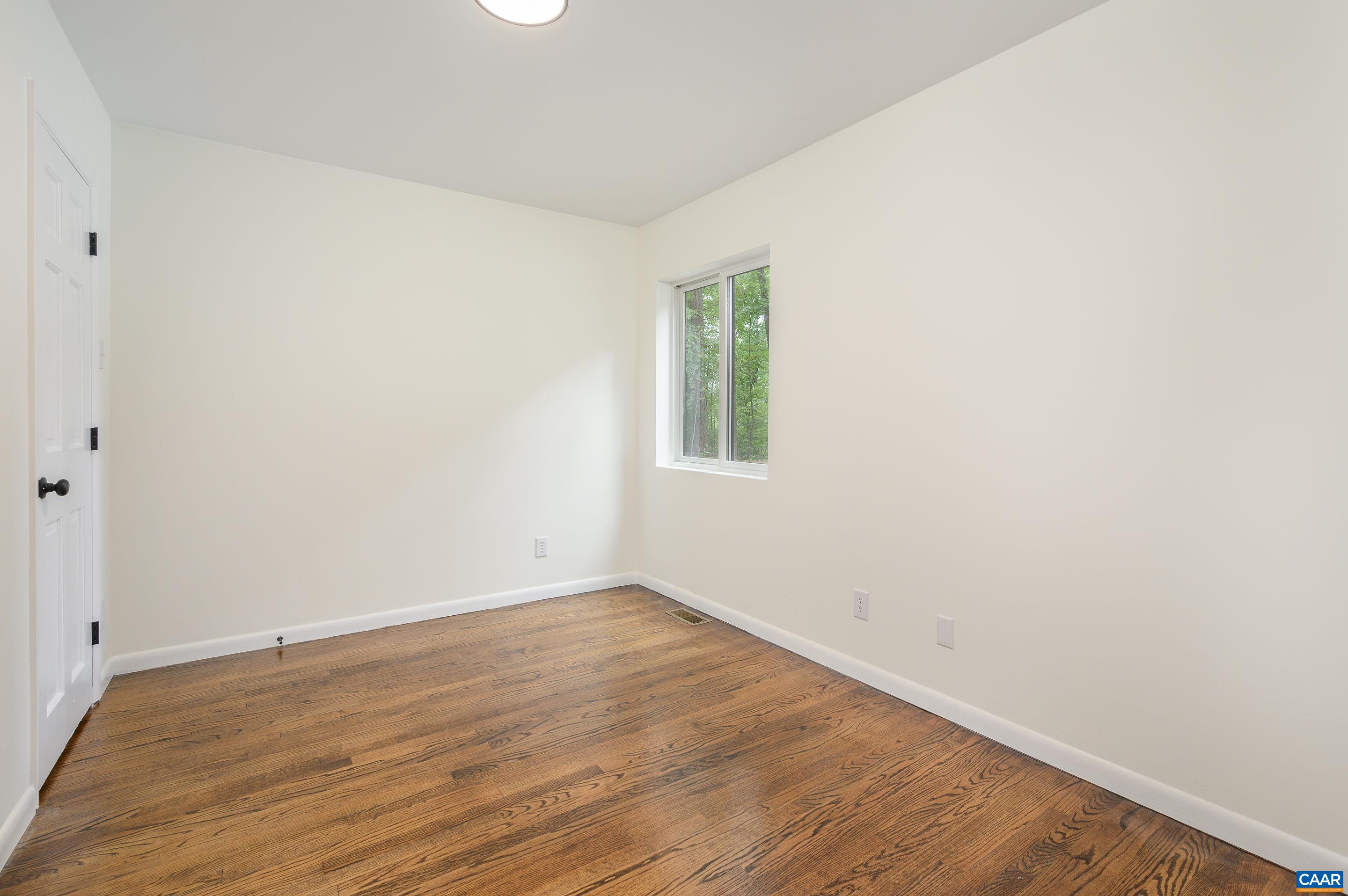 960 Broad Axe Road Charlottesville, VA 22903 - Photo 22 of 39 an empty room with wooden floor and windows