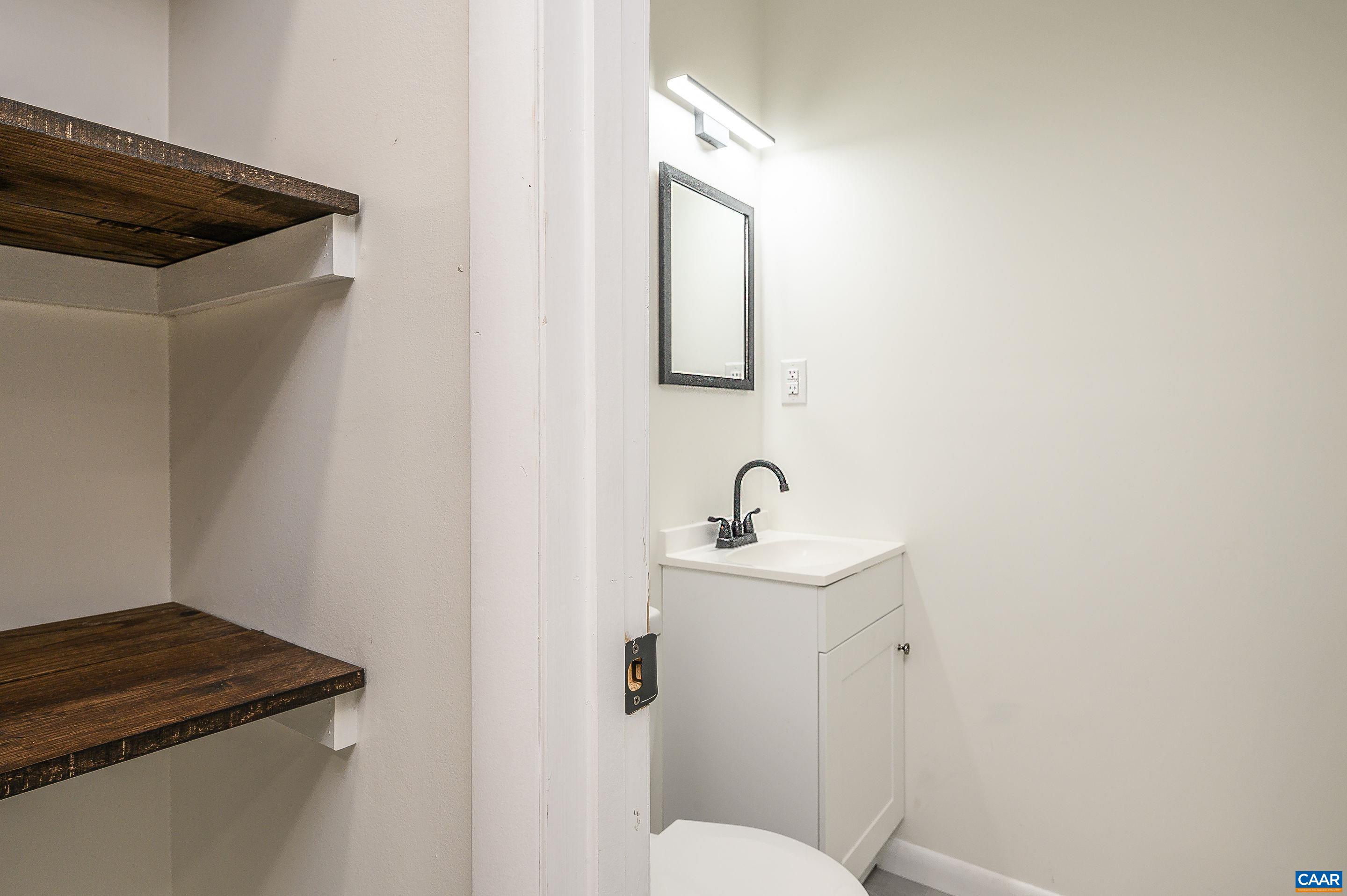 960 Broad Axe Road Charlottesville, VA 22903 - Photo 23 of 39 a bathroom with a sink and mirror with toilet