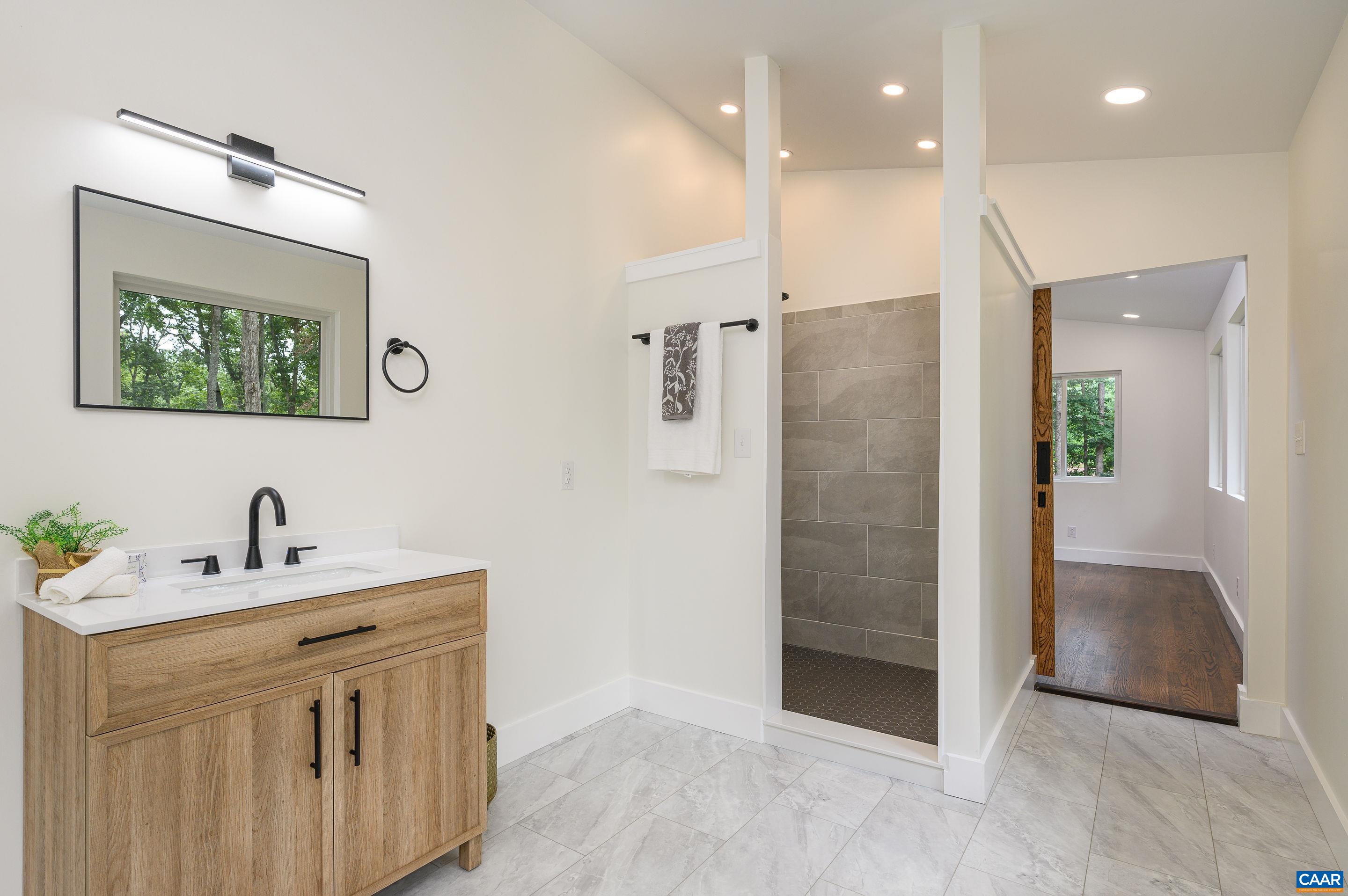 960 Broad Axe Road Charlottesville, VA 22903 - Photo 28 of 39 a bathroom with a double vanity sink a mirror and shower