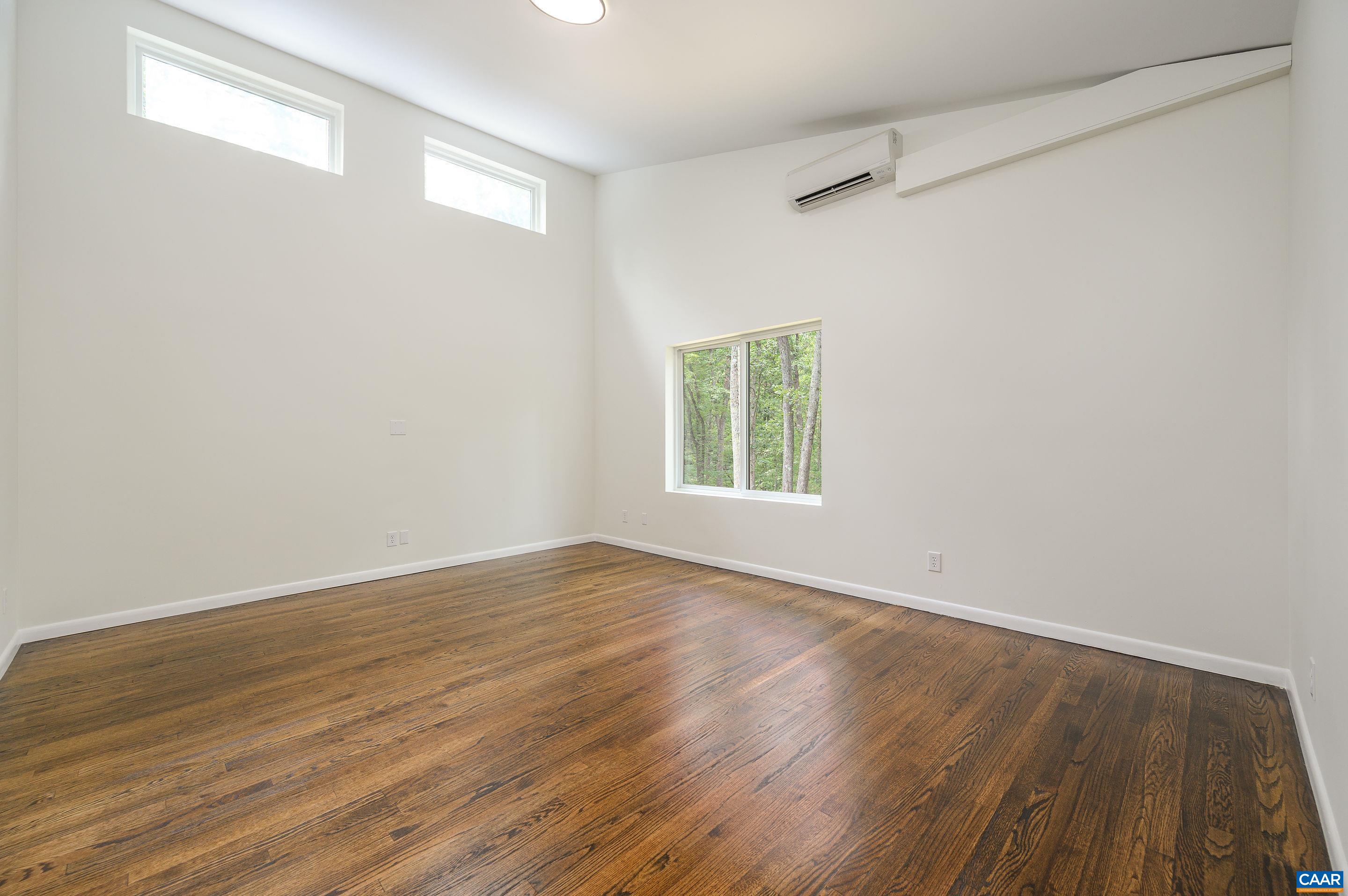 960 Broad Axe Road Charlottesville, VA 22903 - Photo 30 of 39 an empty room with wooden floor and windows