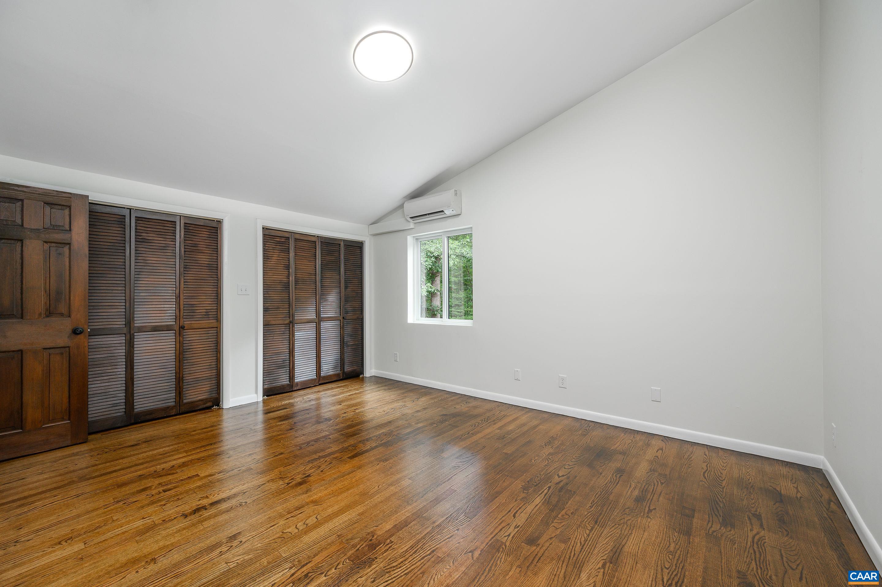 960 Broad Axe Road Charlottesville, VA 22903 - Photo 32 of 39 an empty room with wooden floor and windows