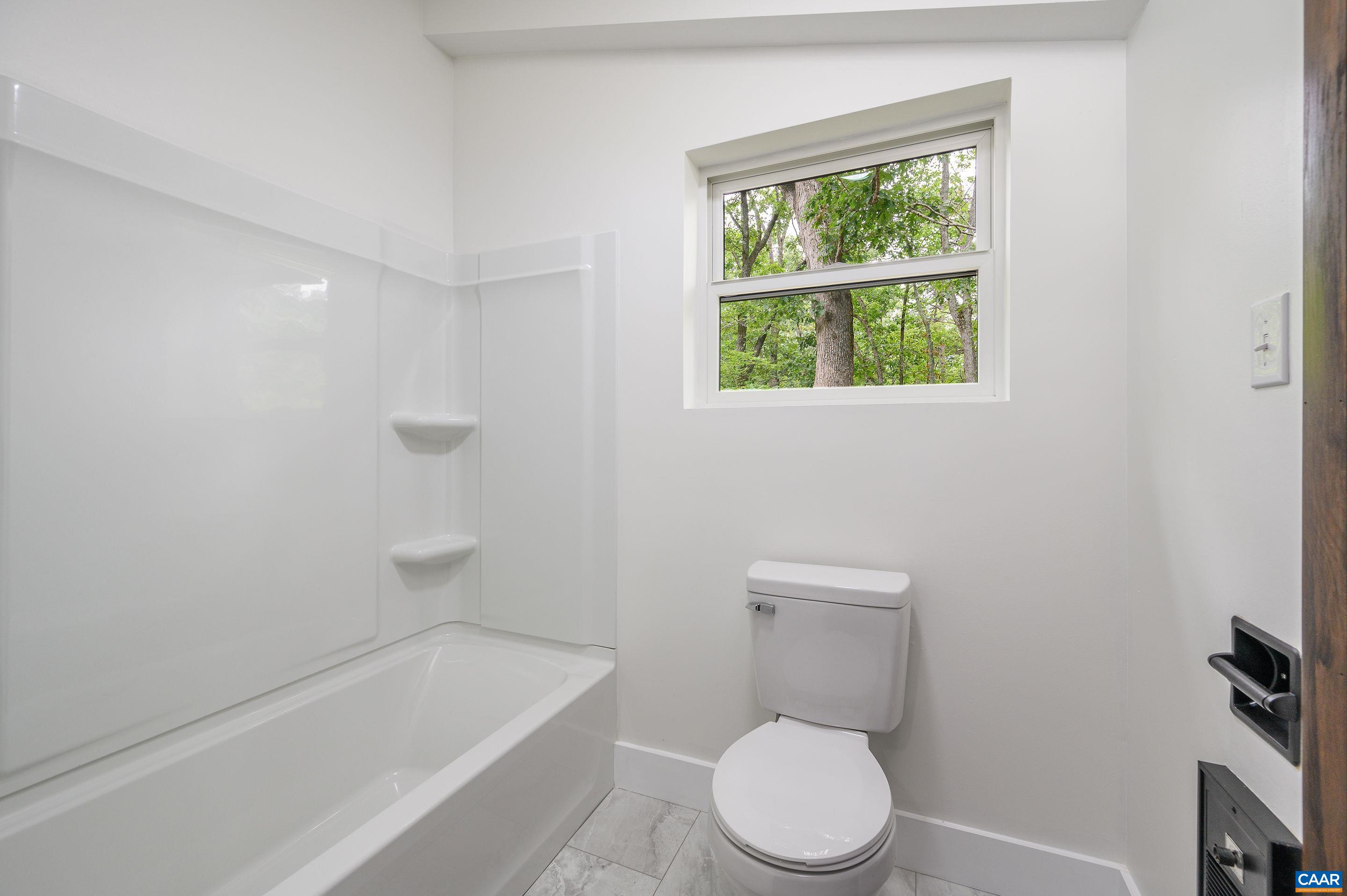 960 Broad Axe Road Charlottesville, VA 22903 - Photo 34 of 39 a white toilet sitting next to a bath tub