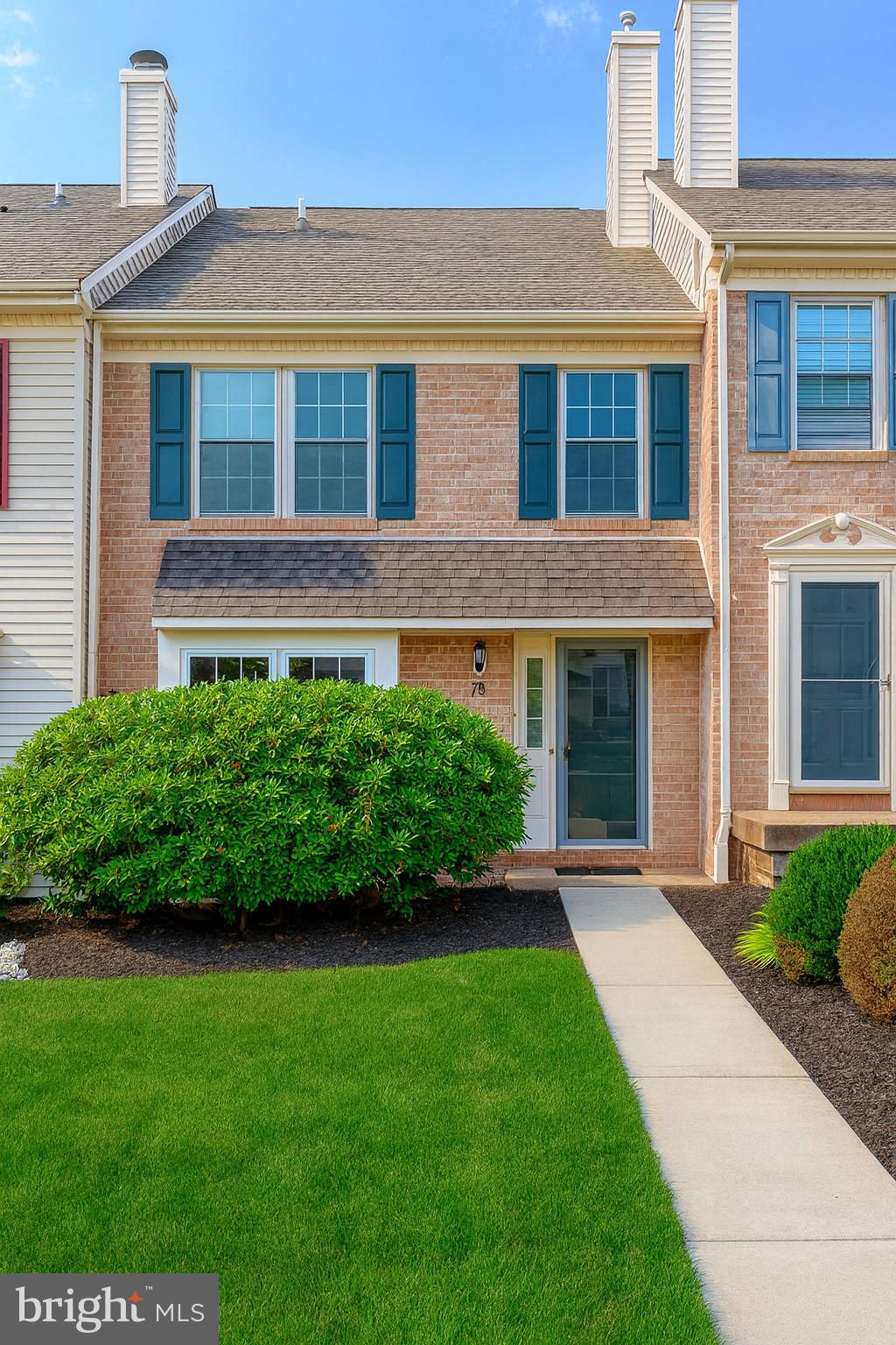 a front view of a house with a yard and porch