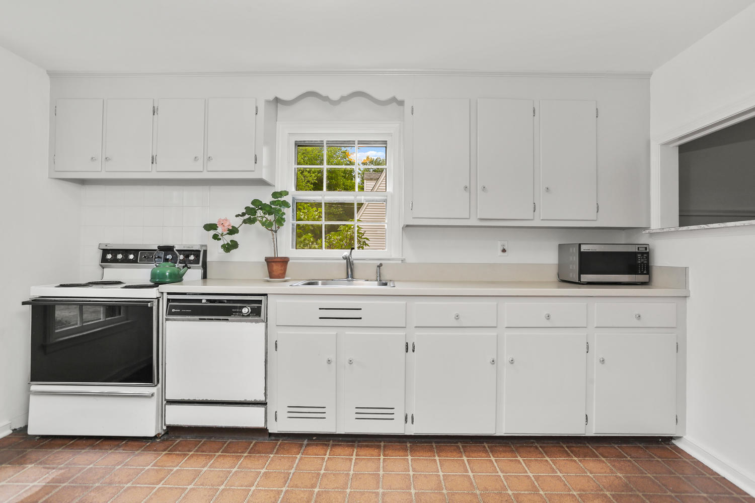 9 Alpine Lane Darien, CT 06820 - Photo 4 of 23 a kitchen with white cabinets and white appliances