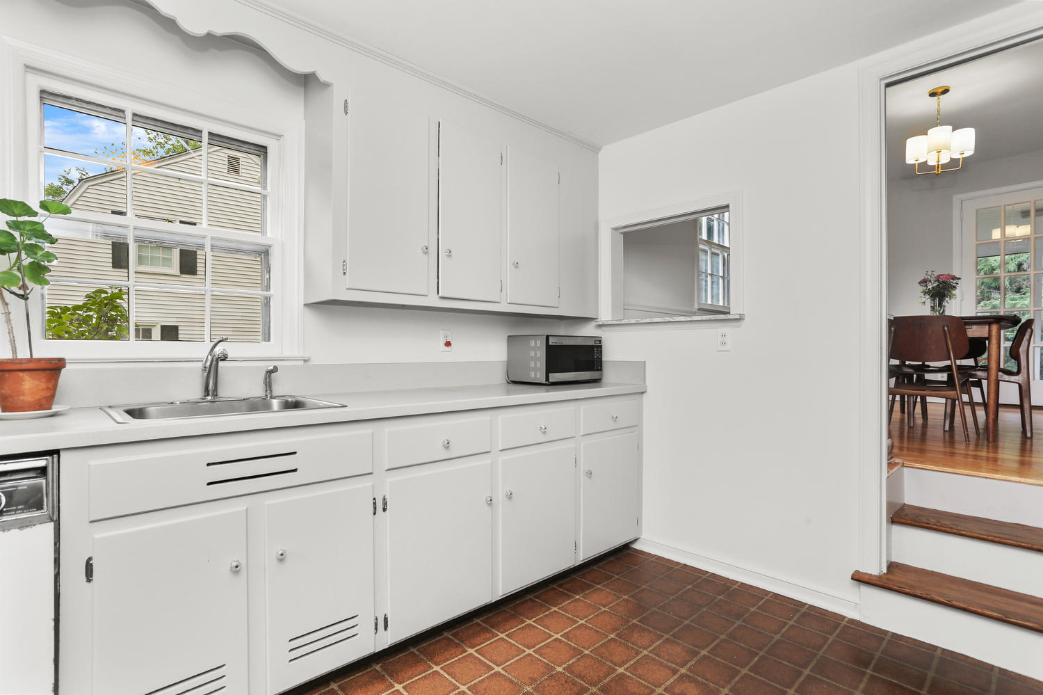 9 Alpine Lane Darien, CT 06820 - Photo 5 of 23 a kitchen with white cabinets and sink