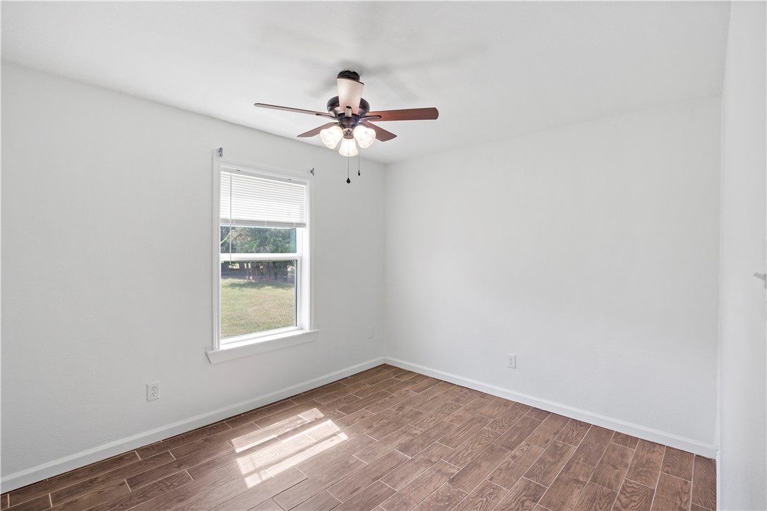 1503 Alpine Circle, Unit A College Station, TX 77840 - Photo 15 of 18 an empty room with a window and a fan