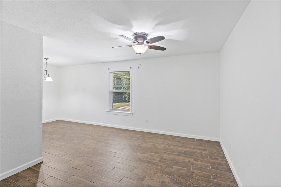 1503 Alpine Circle, Unit A College Station, TX 77840 - Photo 5 of 18 an empty room with windows and fan