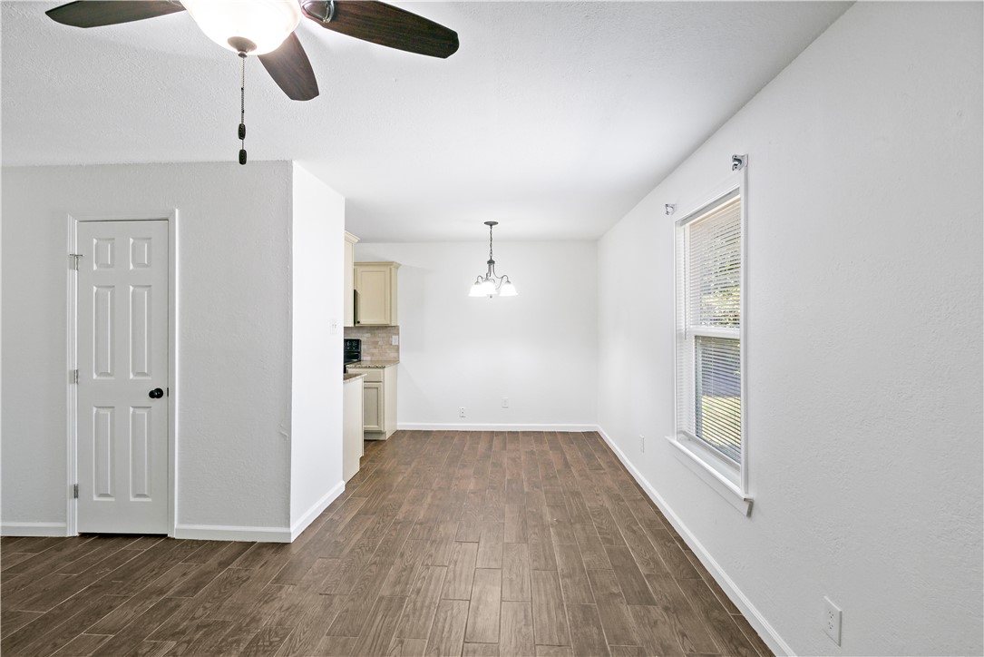 1503 Alpine Circle, Unit A College Station, TX 77840 - Photo 8 of 18 wooden floor in an empty room with a window