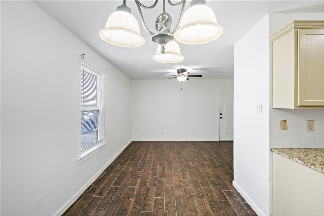 1503 Alpine Circle, Unit A College Station, TX 77840 - Photo 9 of 18 a view of a room with wooden floor and a chandelier