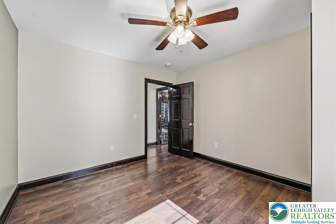 3453 Main Street Slatington, PA 18080 - Photo 14 of 30 Rich hardwood floors complement a modern ceiling fan in this adaptable interior space.