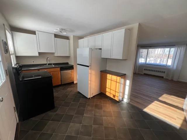 a kitchen with a refrigerator a stove a microwave and cabinets