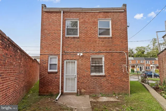 a view of a brick house with many windows