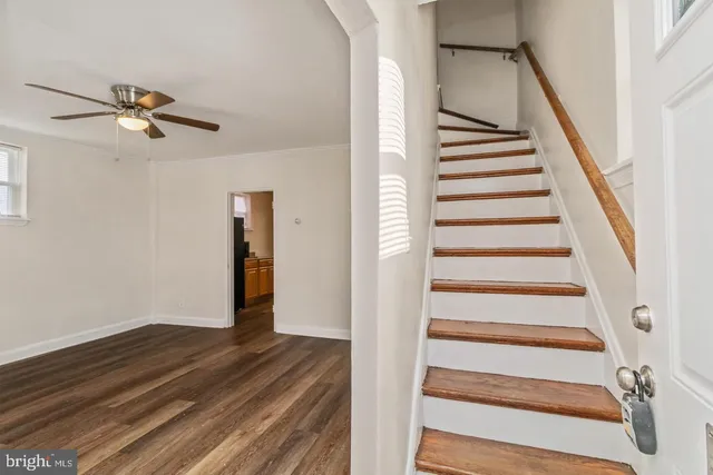 a view of a hallway with wooden floor and entryway