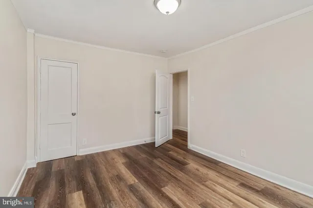 a view of room with wooden floor