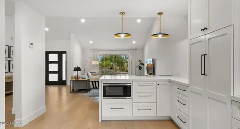a kitchen with stainless steel appliances a stove a sink and a refrigerator