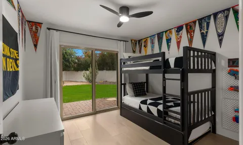 a living room with patio furniture and a floor to ceiling window