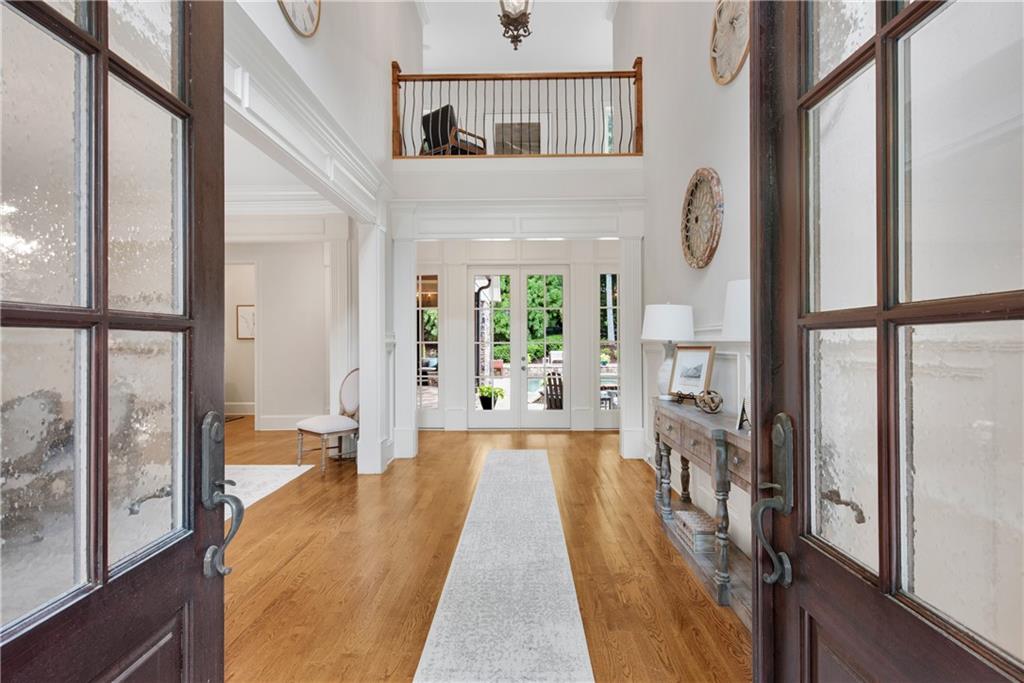 13942 Tree Loft Road Milton, GA 30004 - Photo 10 of 102 a view of a hallway with wooden floor and a living room