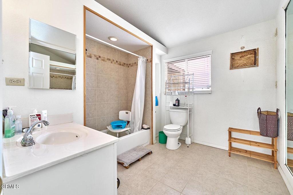 9494 Baker Road Lucerne Valley, CA 92356 - Photo 13 of 56 a bathroom with a sink a toilet and a mirror