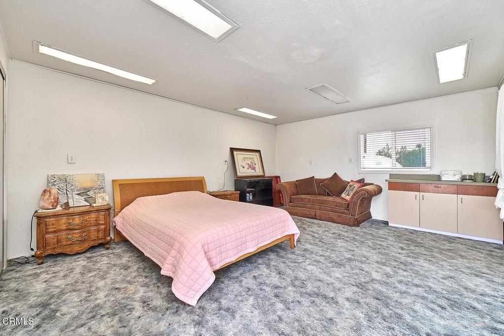 9494 Baker Road Lucerne Valley, CA 92356 - Photo 19 of 56 a bedroom with a large bed and a dresser