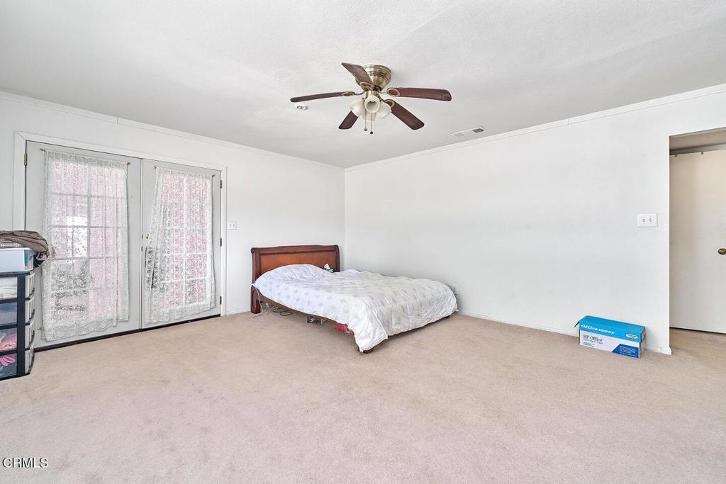 9494 Baker Road Lucerne Valley, CA 92356 - Photo 25 of 56 a bedroom with a bed and a cabinets