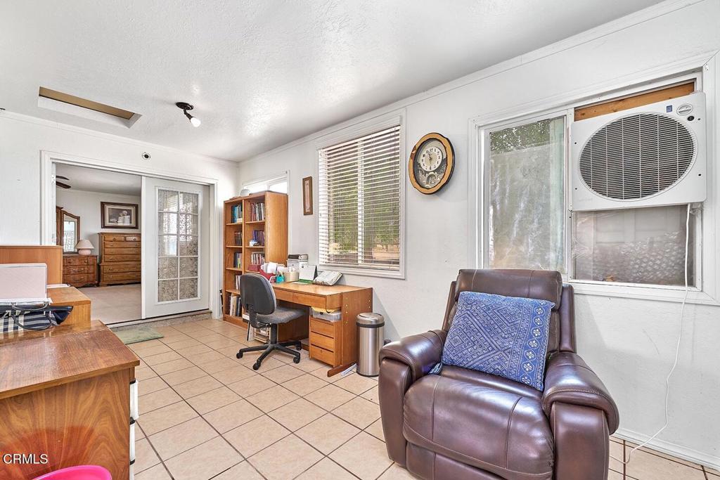 9494 Baker Road Lucerne Valley, CA 92356 - Photo 29 of 56 a living room with furniture and a clock