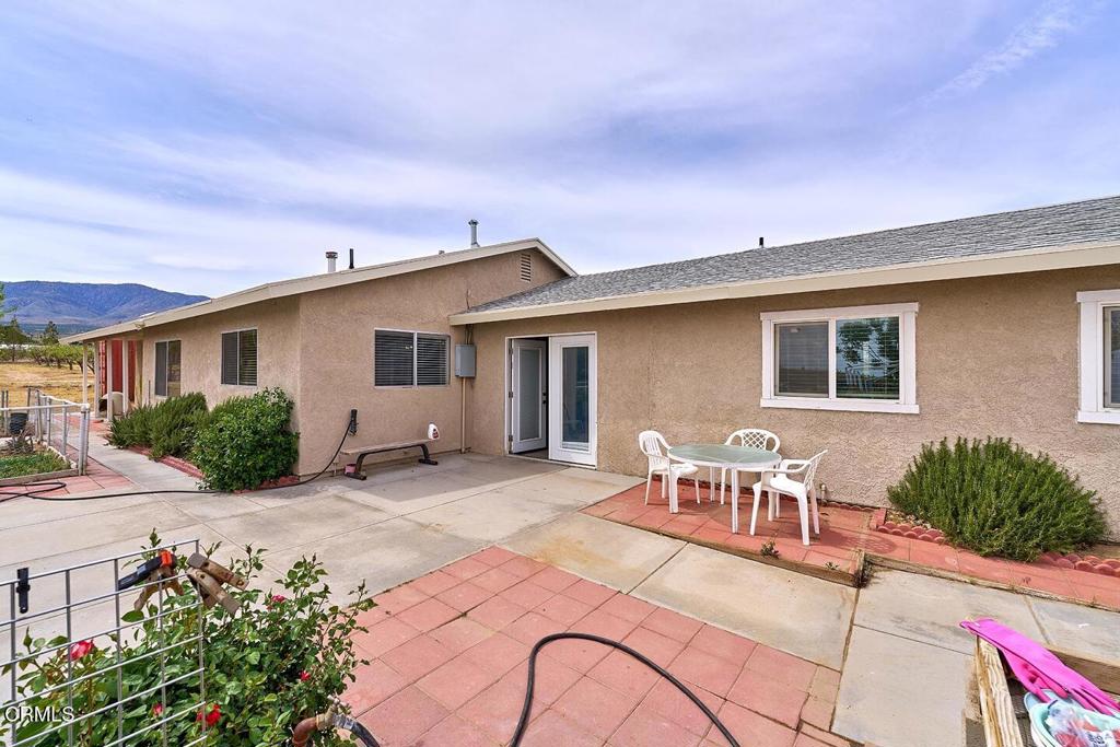 9494 Baker Road Lucerne Valley, CA 92356 - Photo 3 of 56 a view of a house with backyard sitting area and garden