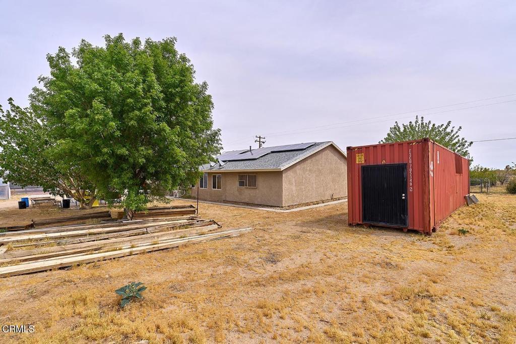 9494 Baker Road Lucerne Valley, CA 92356 - Photo 6 of 56 a view of a house with a yard and a large tree