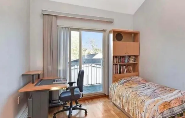 a bedroom with a bed and a table