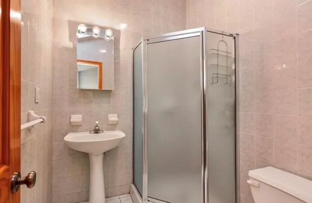 a bathroom with a sink toilet and shower