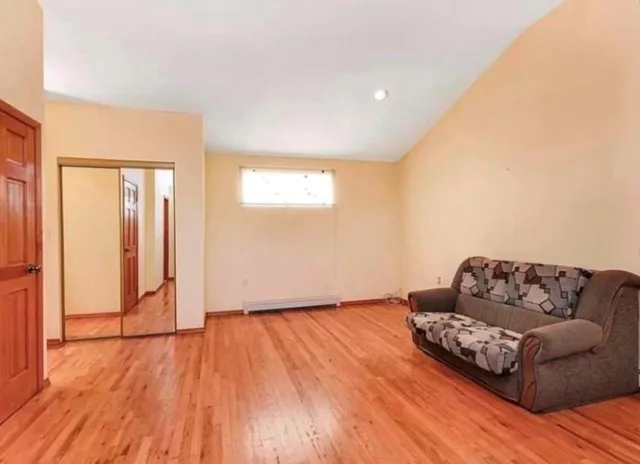 a living room with a couch and a wooden floor
