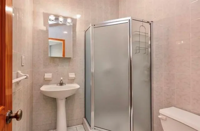 a bathroom with a sink toilet and shower