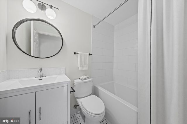 a white toilet sitting next to a bathroom sink