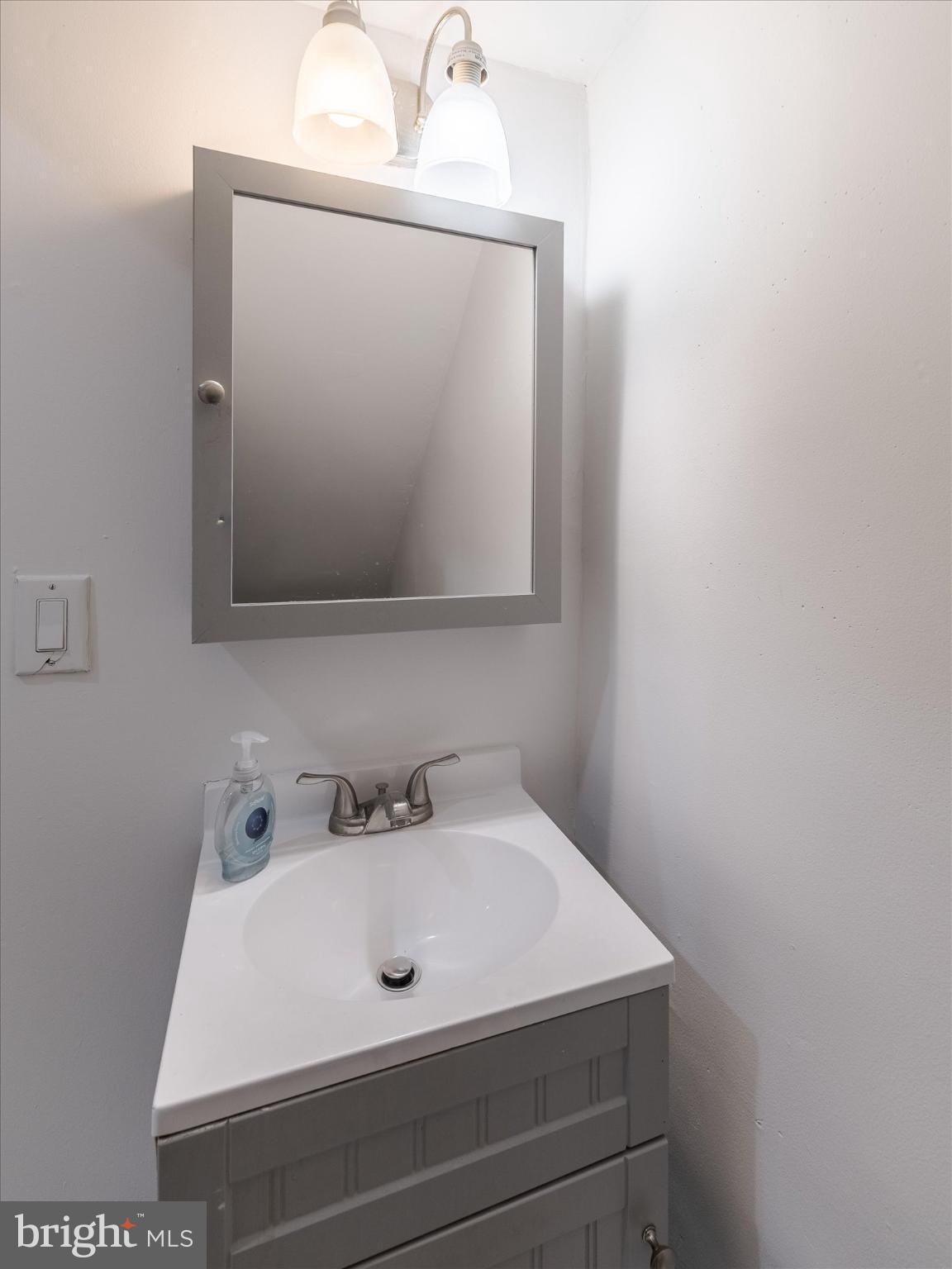 5428 Belmar Street Philadelphia, PA 19143 - Photo 11 of 25 a bathroom with a sink and a mirror