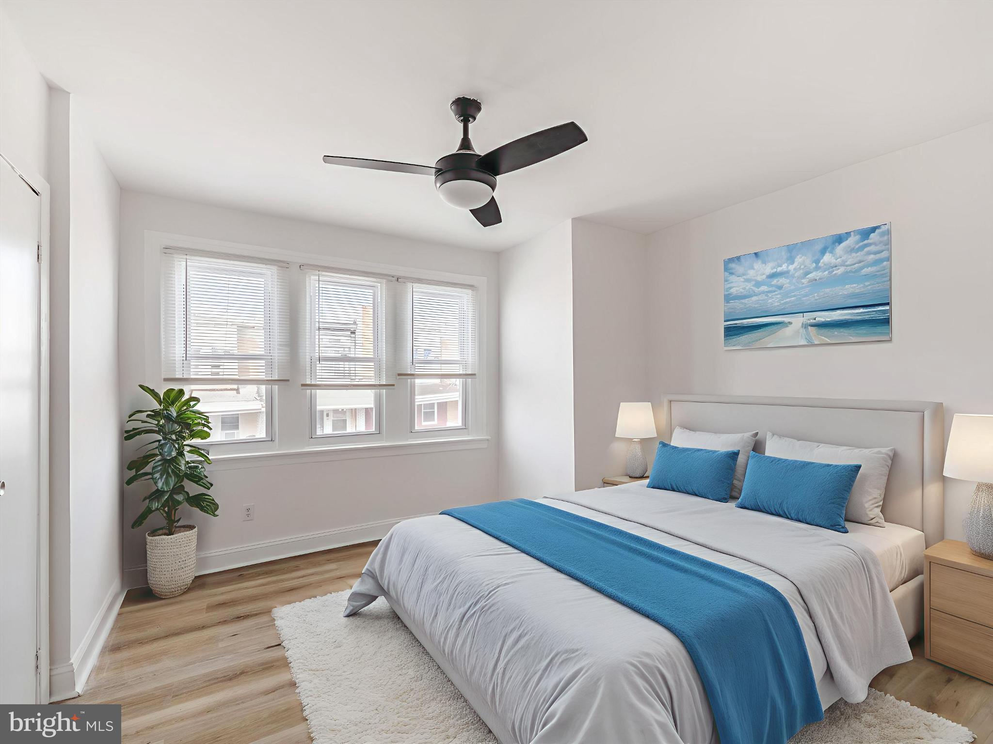 5428 Belmar Street Philadelphia, PA 19143 - Photo 13 of 25 a bedroom with a large bed and potted plant