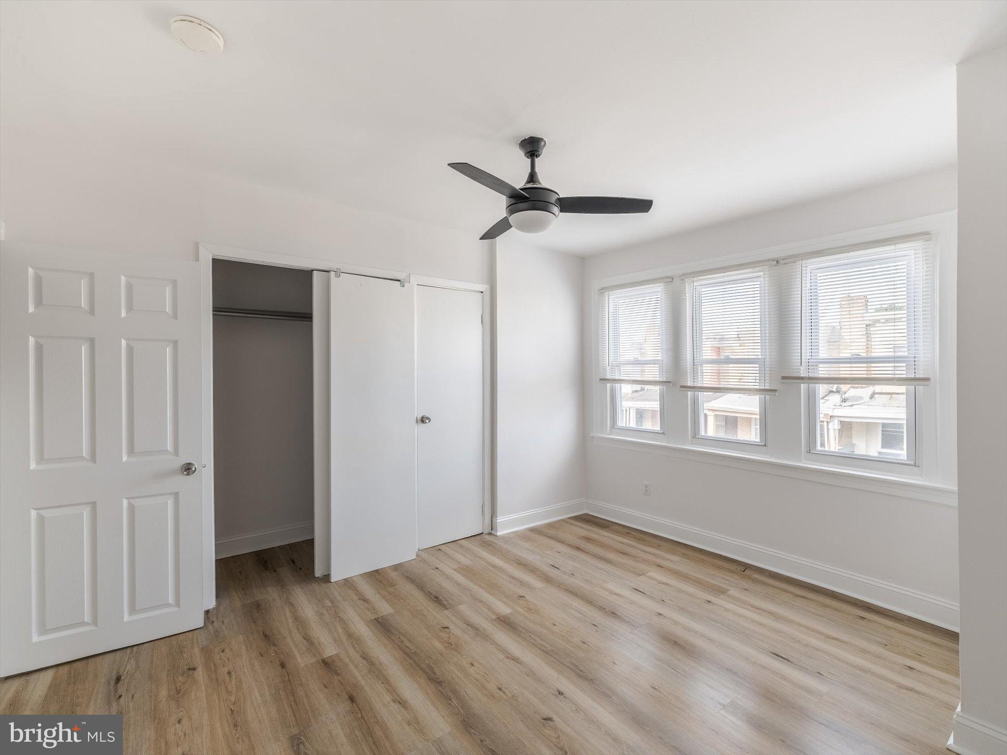 5428 Belmar Street Philadelphia, PA 19143 - Photo 14 of 25 a view of empty room with wooden floor and fan