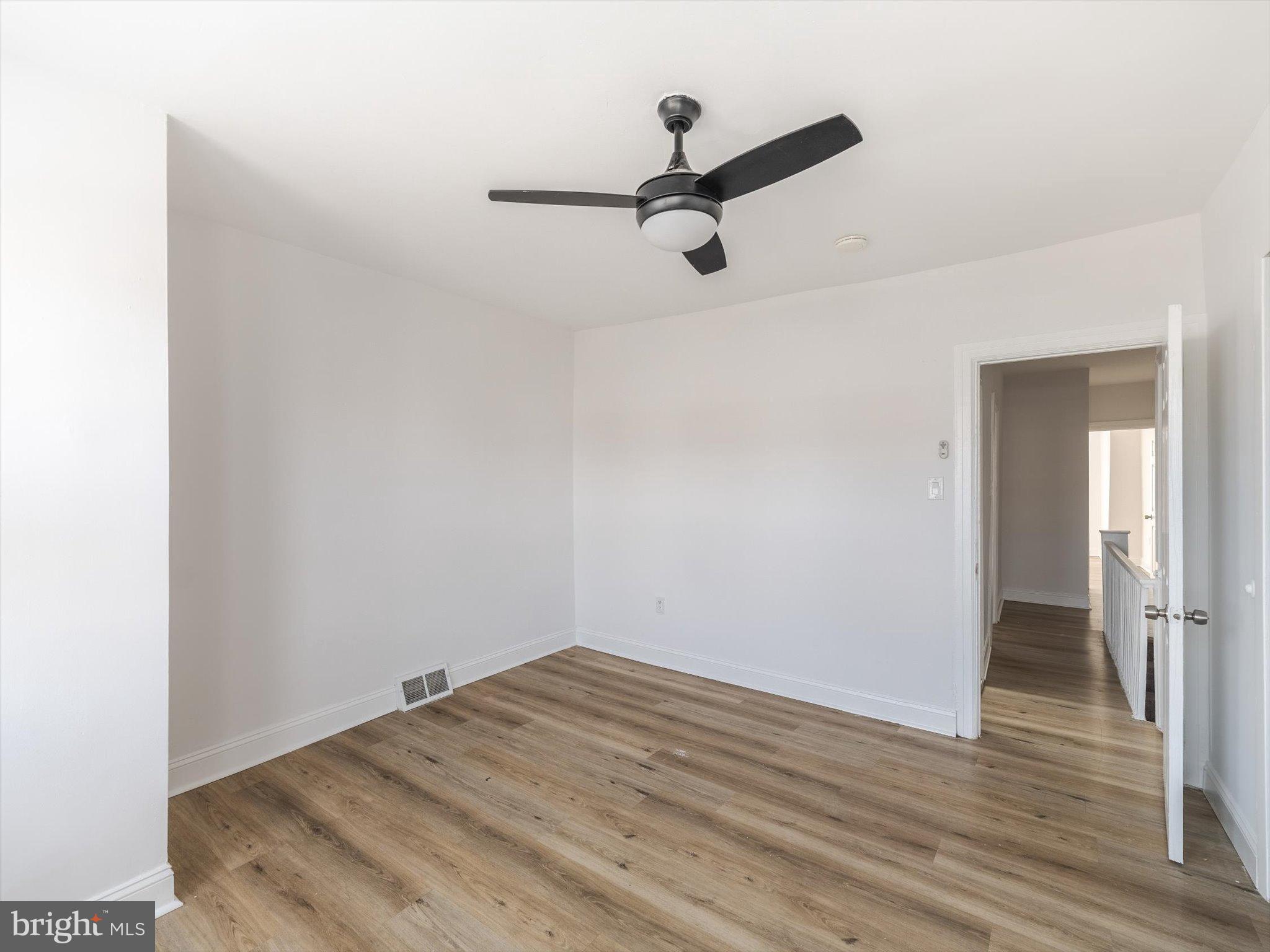 5428 Belmar Street Philadelphia, PA 19143 - Photo 16 of 25 a view of a room with wooden floor and a ceiling fan