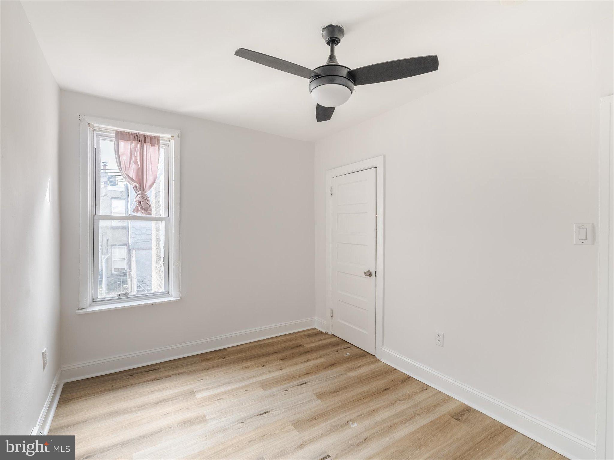 5428 Belmar Street Philadelphia, PA 19143 - Photo 18 of 25 an empty room with wooden floor closet and windows