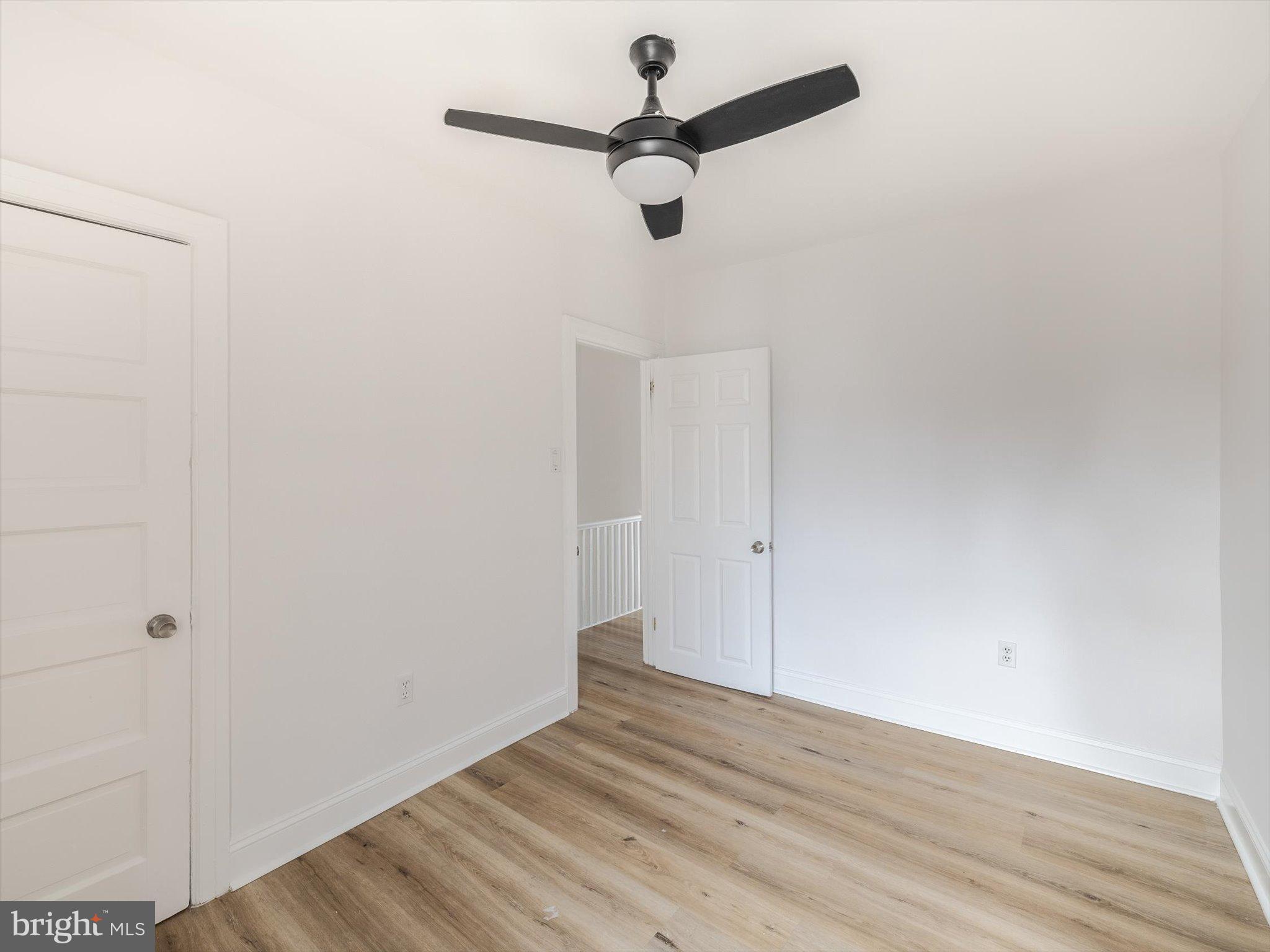 5428 Belmar Street Philadelphia, PA 19143 - Photo 19 of 25 a view of a room with wooden floor and a ceiling fan
