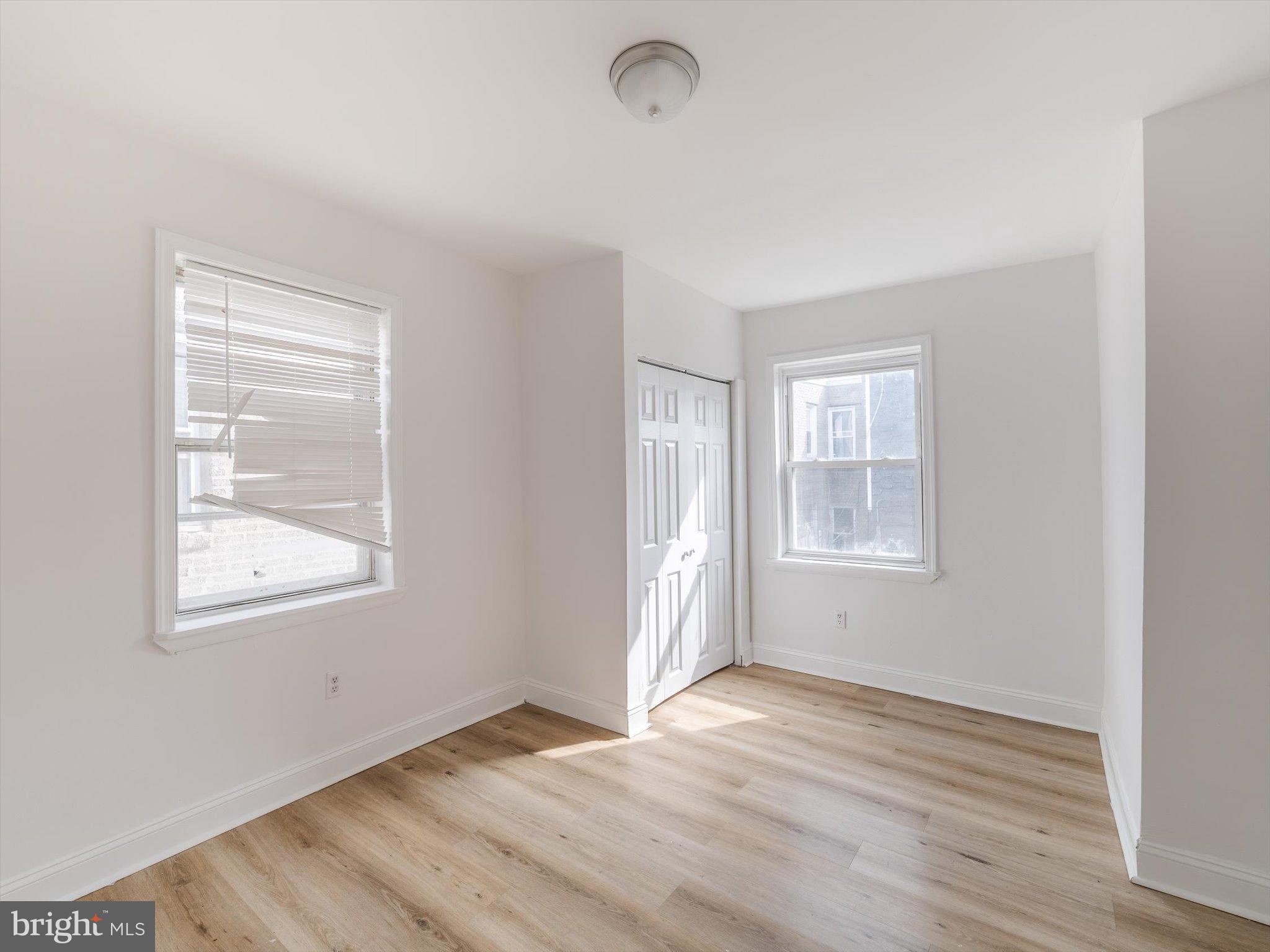 5428 Belmar Street Philadelphia, PA 19143 - Photo 20 of 25 a view of an empty room with wooden floor and a window